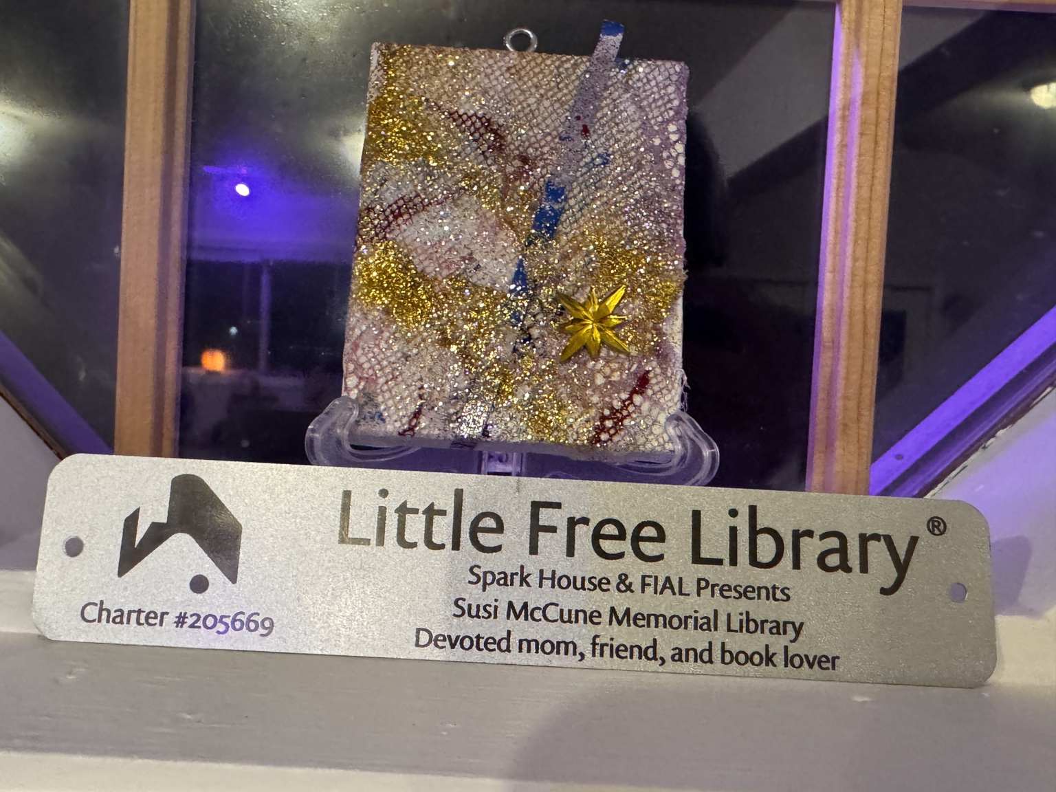 Original Susi McCune Memorial Library plaque naming Spark House and FIAL